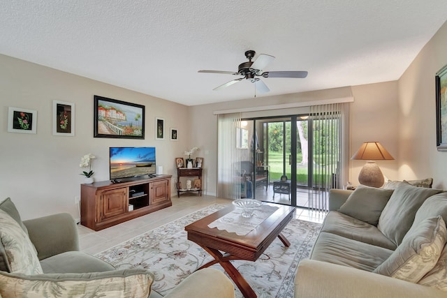 living room with light tile patterned flooring, a textured ceiling, and ceiling fan