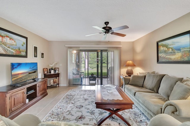 tiled living room featuring a textured ceiling and ceiling fan