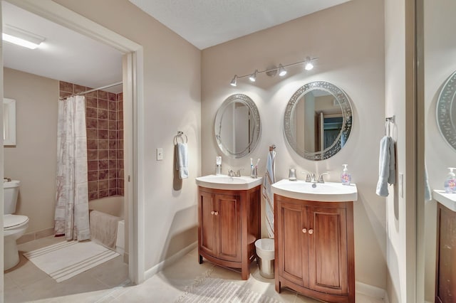 full bathroom with shower / tub combo with curtain, vanity, toilet, a textured ceiling, and tile patterned flooring