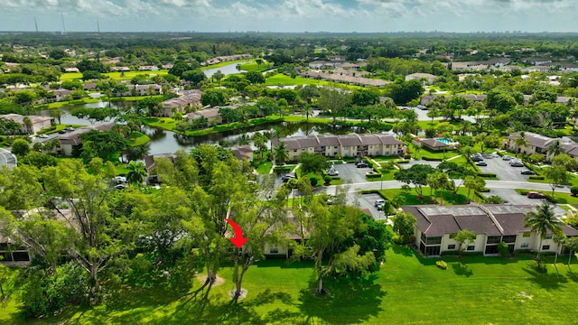 drone / aerial view featuring a residential view and a water view