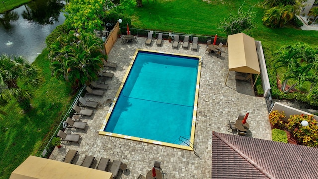 view of swimming pool with a water view and a patio area