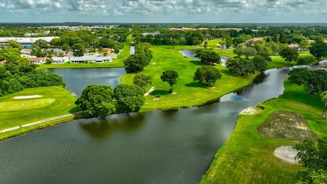 drone / aerial view featuring view of golf course and a water view