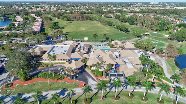 bird's eye view with a water view, a residential view, and golf course view