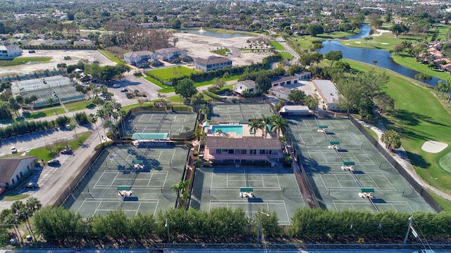 birds eye view of property with view of golf course and a water view