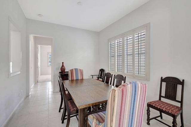 dining room featuring light tile patterned flooring and plenty of natural light