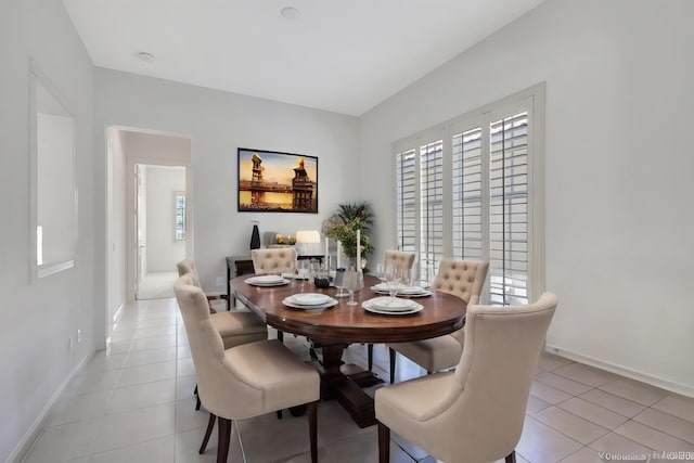 dining space featuring light tile patterned flooring