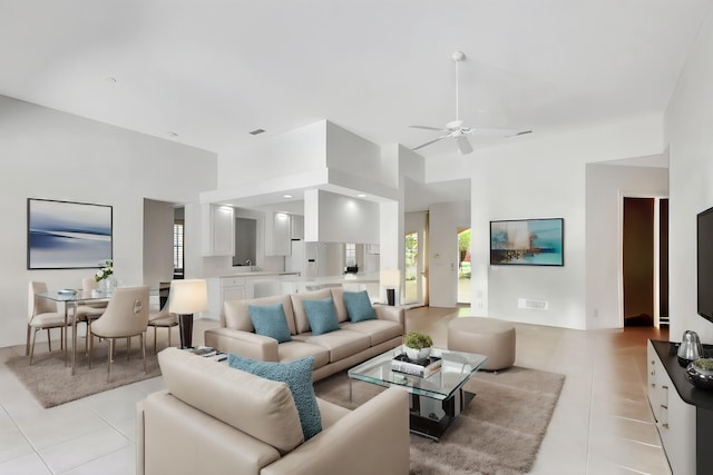 living room featuring light tile patterned floors and ceiling fan