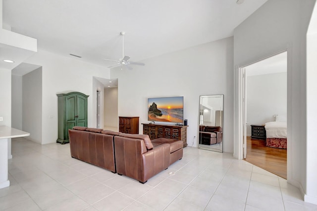 living room with light tile patterned flooring and ceiling fan