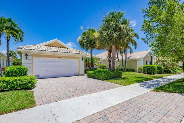 view of front of house featuring a garage and a front lawn