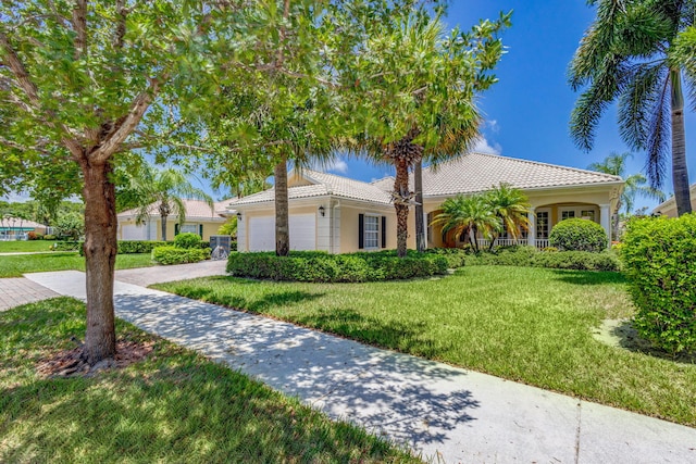 mediterranean / spanish home with a garage and a front yard