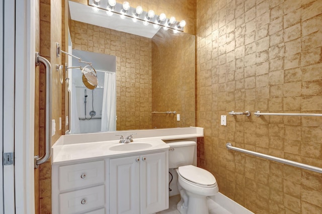 bathroom featuring vanity, tile walls, toilet, and walk in shower