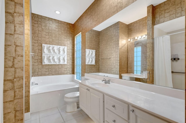 bathroom featuring toilet, tile walls, vanity, a tub, and tile patterned flooring