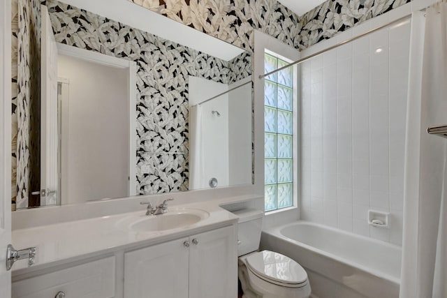 full bathroom with vanity, plenty of natural light, toilet, and tiled shower / bath