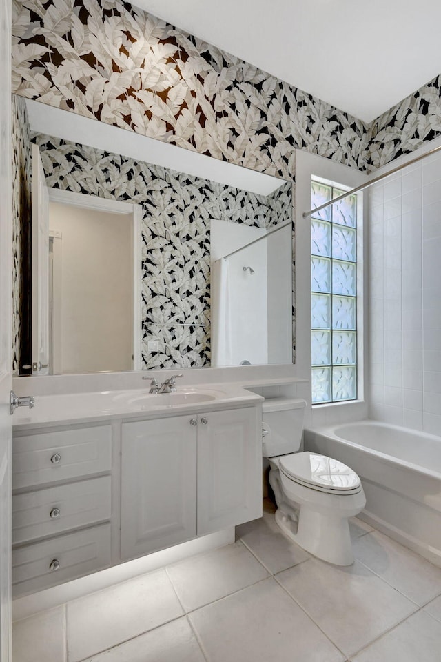 full bathroom with shower / bath combo with shower curtain, tile patterned floors, toilet, and vanity