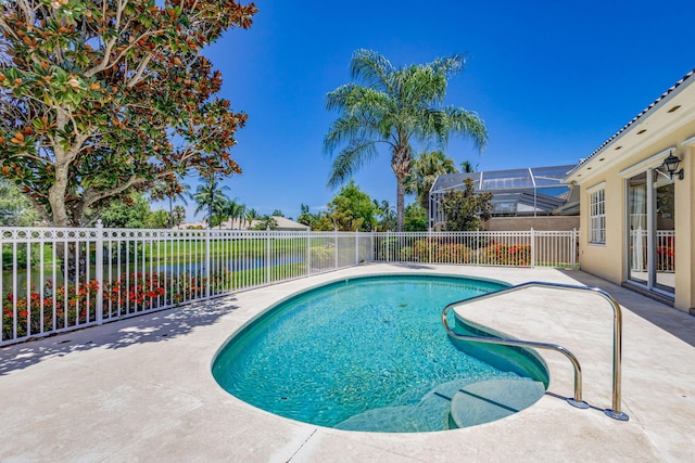 view of pool with a lanai, a patio, and a water view