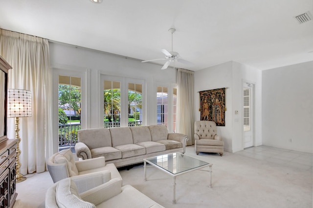 living area featuring carpet, visible vents, and ceiling fan