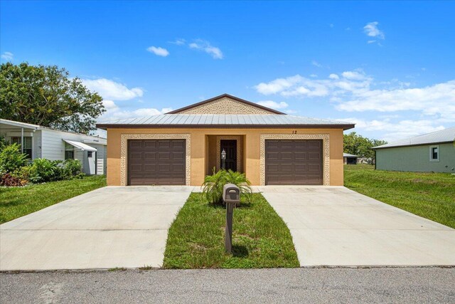 view of front of home featuring a garage and a front lawn