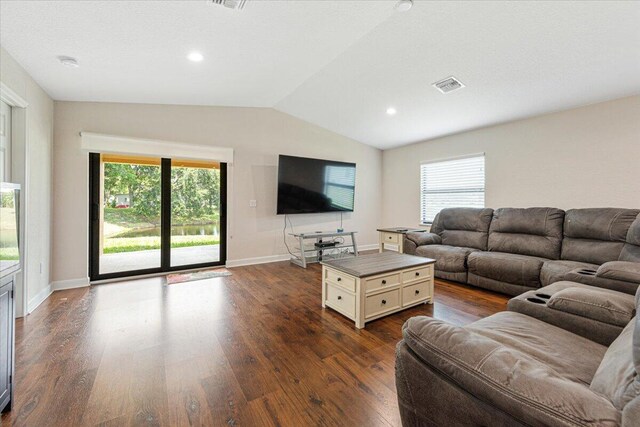 living room featuring vaulted ceiling and hardwood / wood-style floors