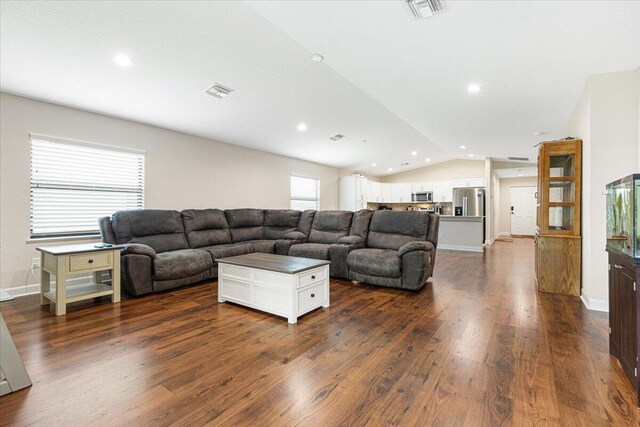 living room featuring hardwood / wood-style flooring and lofted ceiling