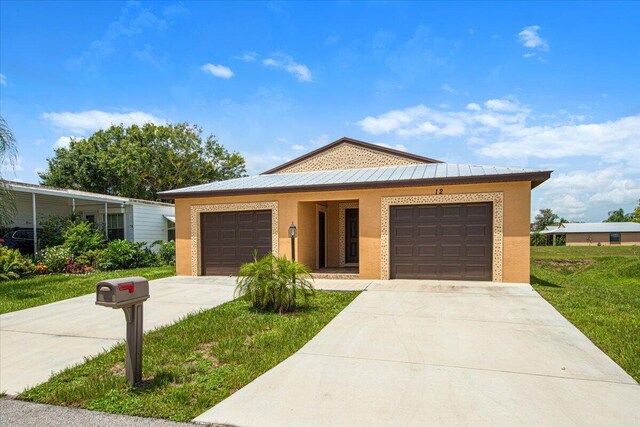 view of front of home featuring a garage and a front lawn