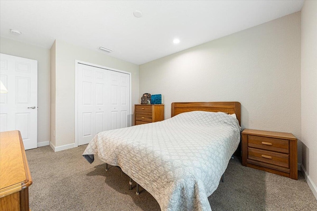 bedroom with a closet and light colored carpet