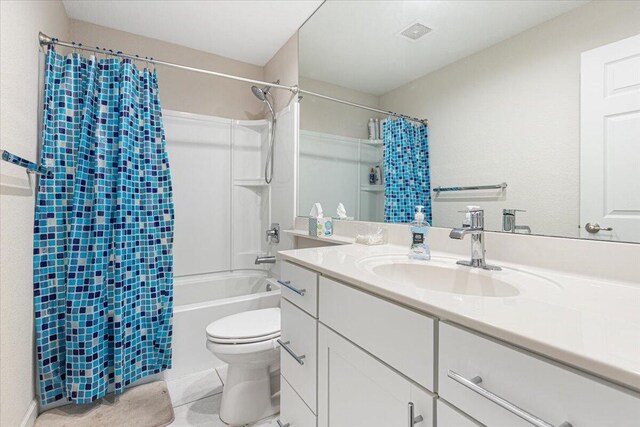 full bathroom with tile patterned flooring, toilet, shower / bathtub combination with curtain, and vanity