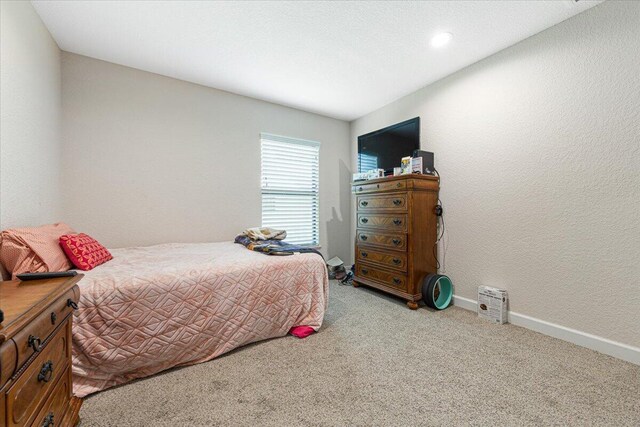 bedroom with light colored carpet