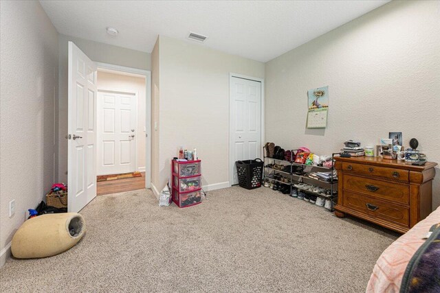 bedroom featuring light carpet