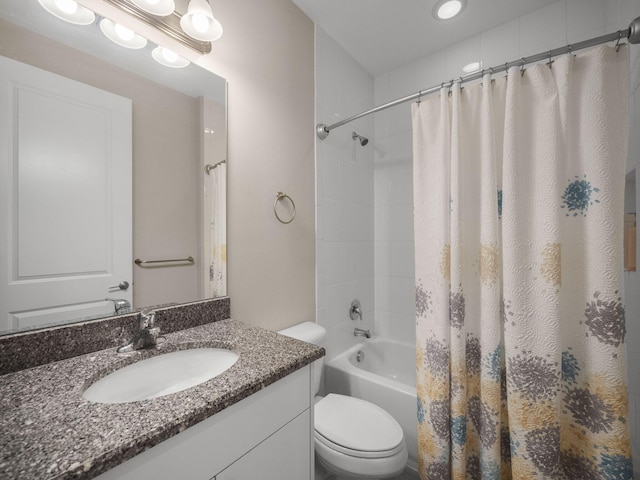 full bathroom with vanity, shower / bath combo, and toilet