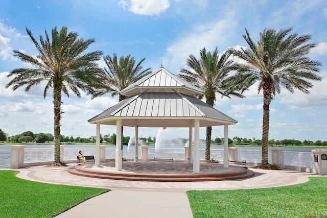 view of community with a gazebo, a water view, and a lawn