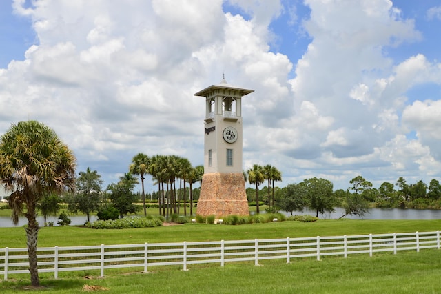 surrounding community featuring a rural view, a lawn, and a water view