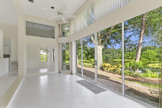 unfurnished sunroom featuring ceiling fan