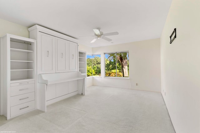 unfurnished bedroom with ceiling fan and light colored carpet