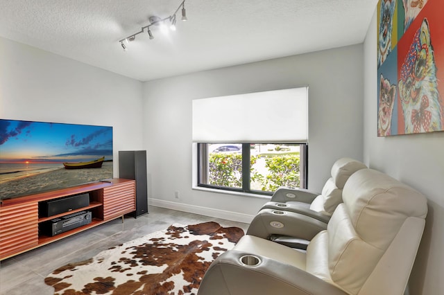 living room with light tile patterned flooring, track lighting, and a textured ceiling