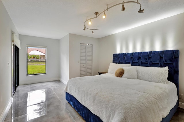 bedroom featuring a closet and concrete floors