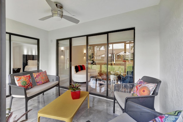 interior space with ceiling fan