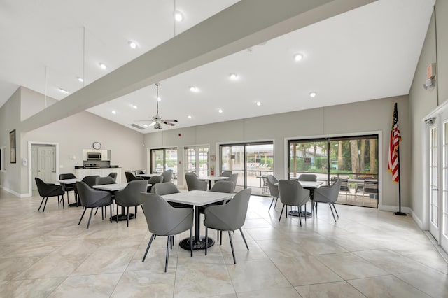 dining area featuring ceiling fan, high vaulted ceiling, and french doors