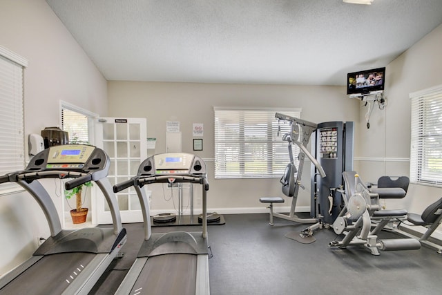 exercise room with a healthy amount of sunlight and a textured ceiling