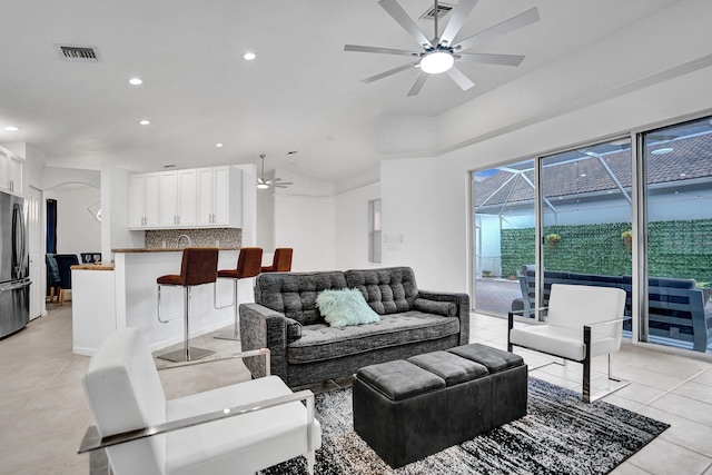 living room featuring ceiling fan and light tile patterned flooring