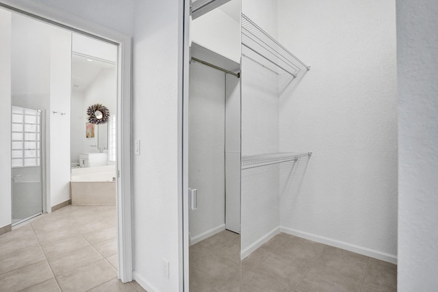 spacious closet with light tile patterned flooring