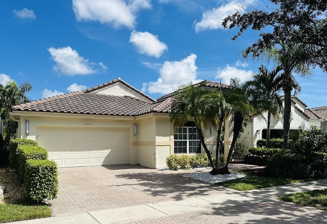 mediterranean / spanish-style house with a garage