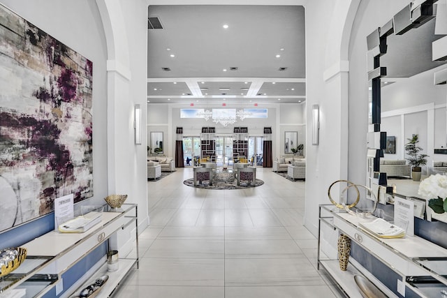 foyer with light tile patterned floors and a high ceiling