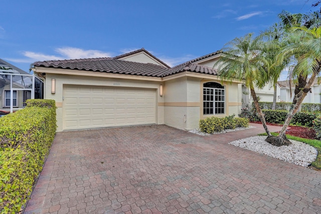 mediterranean / spanish-style home with a garage