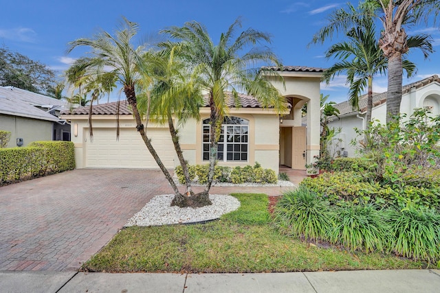 mediterranean / spanish-style house with a garage