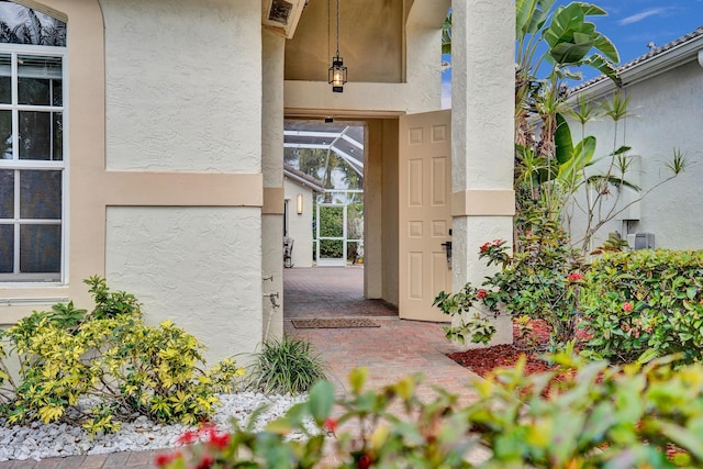 view of exterior entry featuring a patio area