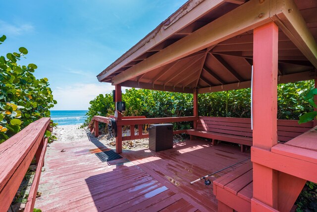 wooden deck with a gazebo and a water view