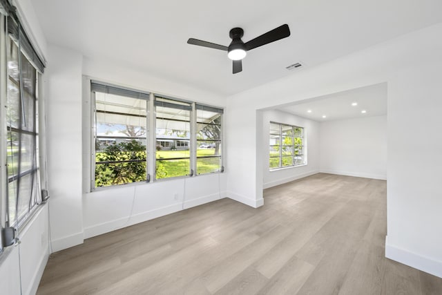 spare room with light hardwood / wood-style floors and ceiling fan