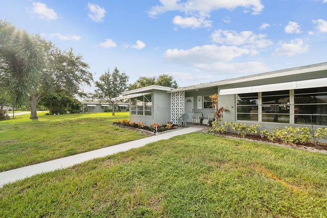 ranch-style home featuring a front yard