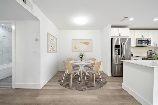 dining room with light hardwood / wood-style flooring