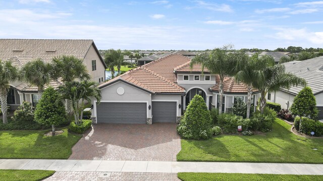 mediterranean / spanish-style house with a front lawn